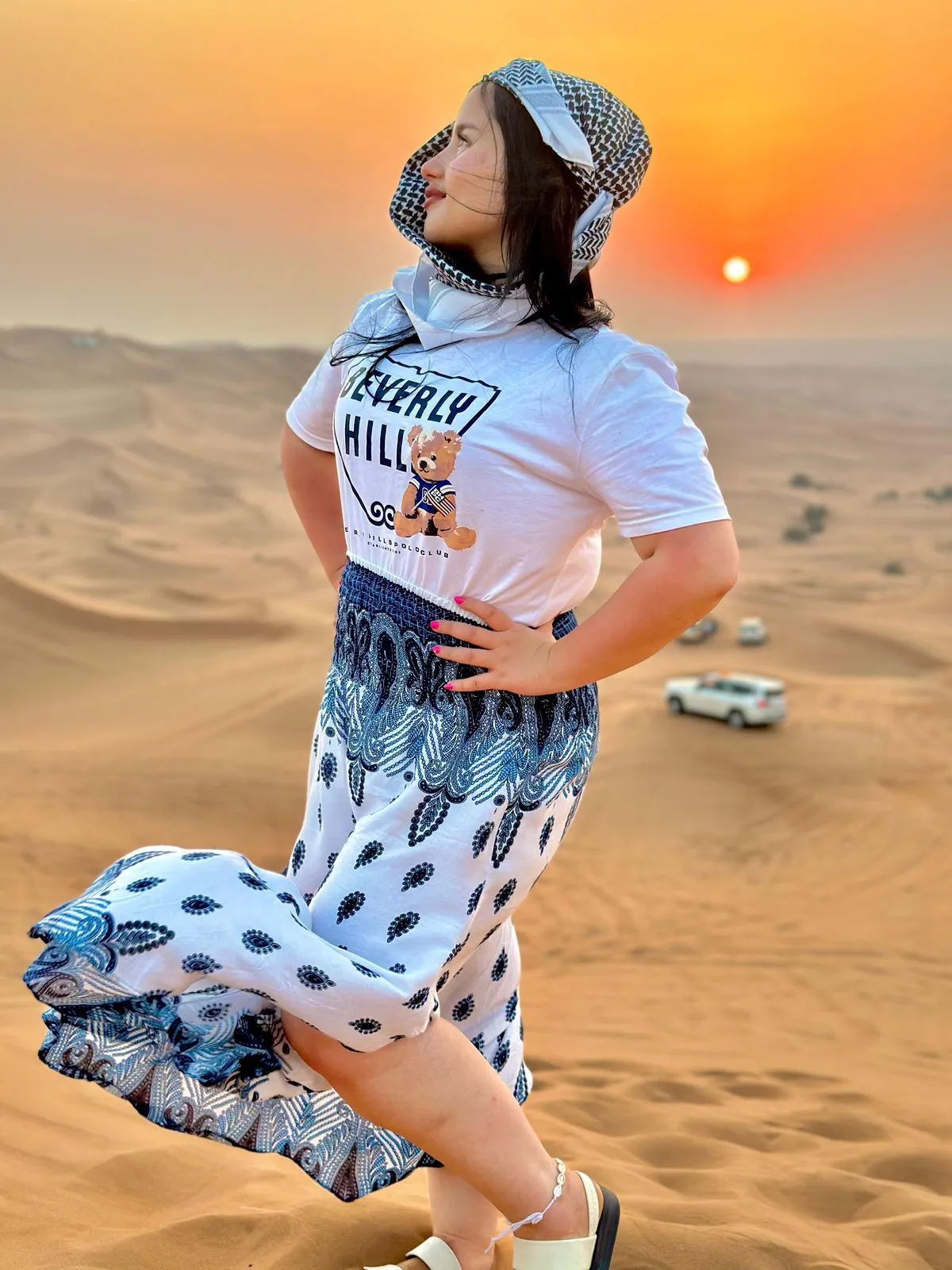 Guest posing for photos in the golden dunes
